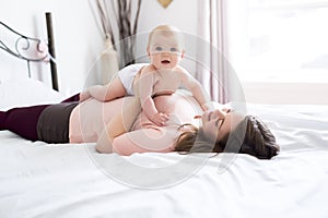 Happy family. Mother and baby playing and smiling under a blanket