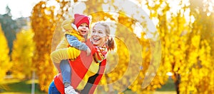 Happy family mother and baby son on autumn walk