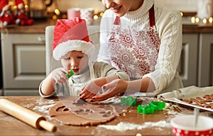 Happy family mother and child bake christmas cookies