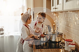 Happy family mother and child bake christmas cookies