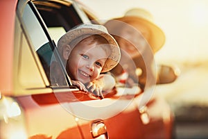 Happy family mother and child boy goes to summer travel trip in car