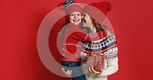 Happy family mother and child daughter with christmas gifts on r