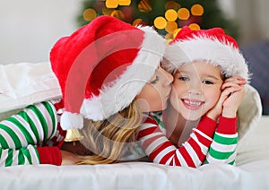 Happy family mother and child daughter in pajamas opening gifts