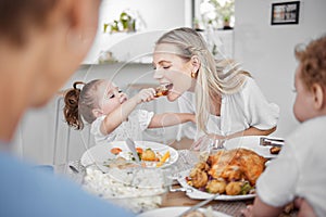 Happy family, mother and child eating chicken and vegetables in a healthy meal for dinner in Germany, Berlin. Food