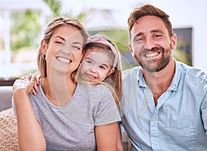 Happy family, mother with child and father relax on living room sofa with a smile while bonding together at home. Mom