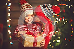 Happy family mother and child girl with Christmas present