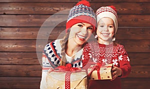 Happy family mother and child girl with Christmas present