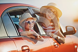 Happy family mother and child girl goes to summer travel trip in car