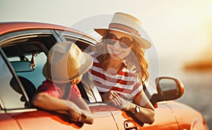 Happy family mother and child girl goes to summer travel trip in car