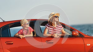 Happy family mother and child girl goes to summer travel trip in car
