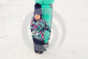 Happy family. Mother and child girl on a winter walk in nature.