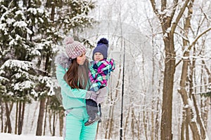 Happy family. Mother and child girl on a winter walk in nature.