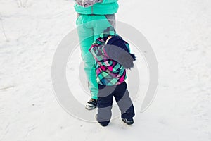 Happy family. Mother and child girl on a winter walk in nature.