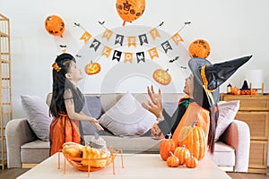 Happy family mother and child happy girl with Halloween at home together beautifully decorated. pretending to release