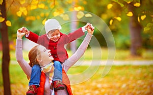 Happy family: mother and child little daughter play cuddling on