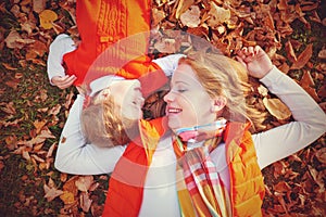 Happy family: mother and child little daughter play cuddling on