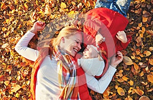 Happy family: mother and child little daughter play cuddling on