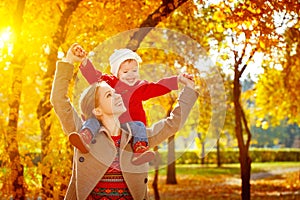 Happy family: mother and child little daughter play cuddling on