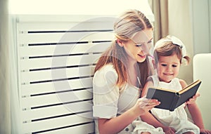 Happy family mother child little girl reading book