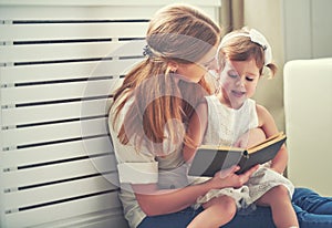 Happy family mother child little girl reading book