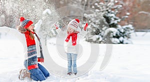 Happy family mother and child playing on winter walk