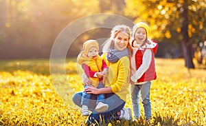 Happy family mother and children on autumn walk