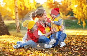 Happy family mother and children on autumn walk