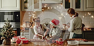 Happy family mother and children bake christmas cookies