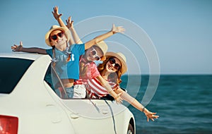 Happy family mother and children girls goes to summer travel trip in car photo