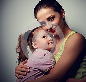 Happy family. Mother cuddling daughter with love