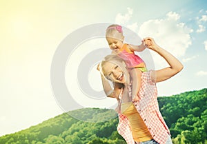 Happy family. mother and daughter baby girl playing on nature