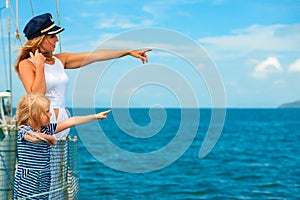 Happy family - mother, daughter on board of sailing yacht.