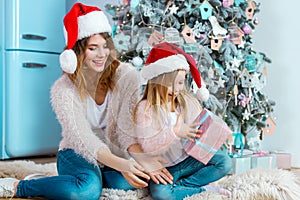 Happy family mother and daughter celebrating Merry Christmas and Happy New Year