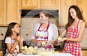 Happy family mother, daughter cooking food on a kitchen