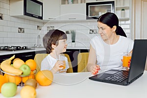 Happy family mother and daughter little girl, eat healthy vegetarian food, lots of fruit