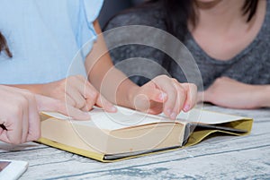 happy family mother and daughter teaching read a book at home.