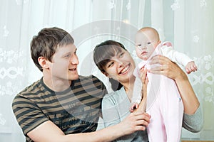 Happy family - mother, father and baby