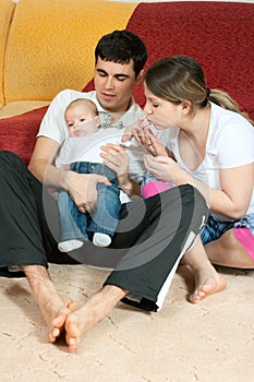 Happy family - mother, father and baby