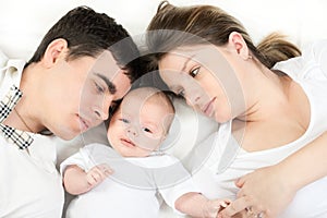 Happy family - mother, father and baby