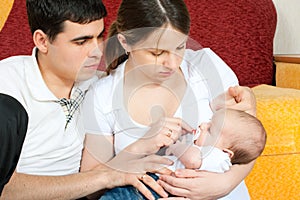 Happy family - mother, father and baby