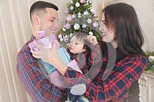 Happy family mother father baby with gift boxes near christmas t