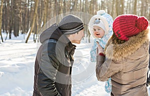 Happy family - Mother, father and child boy on a winter walk.