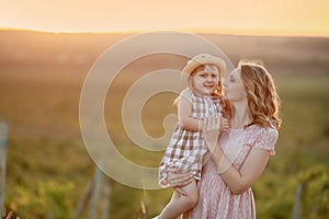 Happy family: mother father and child daughter on nature on sunset