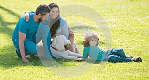 Happy family mother father and child son with pet dog on nature.