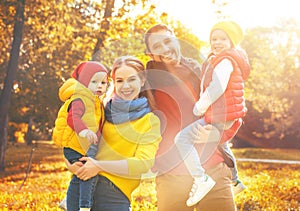 Happy family mother, father and children on an autumn walk