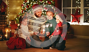 Happy family   celebrate Christmas and new year, light sparklers