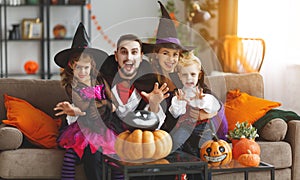 Happy family mother father and children in costumes and makeup o