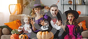 Happy family mother father and children in costumes and makeup o