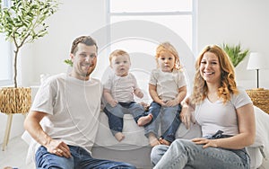 happy family mother, father and children having fun in bed in bedroom at home