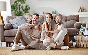 Happy family mother father and children at home on couch